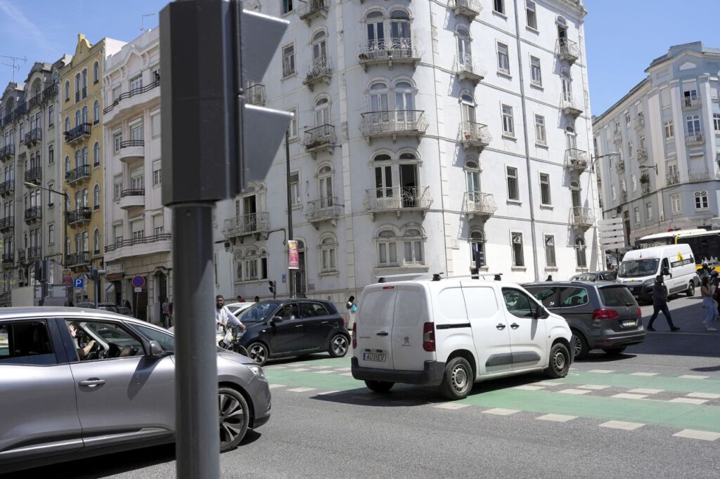 Motorists drive past traffic lights that stopped working following a power outage in downtown Lisbon, Portugal, on Monday.